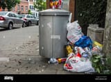 overfull-rubbish-bin-garbage-can-with-trash-around-and-beer-cans-piled-E7FM7H