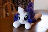 3645864__safe_artist-colon-azgchip_rarity_pony_unicorn_g4_female_horn_indoors_irl_lying+down_mare_photo_plushie_prone_solo_table