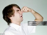 portrait-of-man-holding-nose