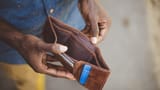 third-world-male-holding-empty-wallet-wide-scaled-e1600370465924