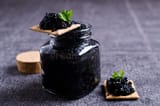 black-caviar-cracker-dark-background-selective-focus-67643944