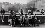 people sitting in a park in warsaw, poland 1987