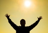 silhouette-of-a-man-against-the-background-of-the-sun-and-yellow-at-sunset-sky-hands-are-raised-up-to-the-sun-photo[1]