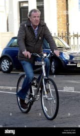 jeremy-clarkson-arrives-at-his-home-in-west-london-on-a-bicycle-as-G7TJ96