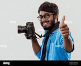 professional-photographer-having-dslr-camera-taking-pictureindian-man-photography-enthusiast-taking-photo-while-standing-on-blu-2M6WR6D