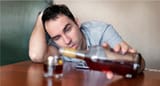 653ab96fe744f468b47f00d7_A man holding a bottle of alcohol