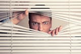 depositphotos_35875495-stock-photo-man-and-window-blinds