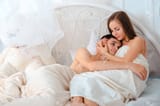 61594356-sweet-young-couple-in-love-hugging-in-the-bed