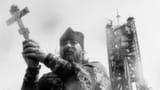 Orthodox priest in front of a launching site_1736192990180316