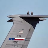 C-5 Galaxy with two crew on top of tail