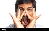 frontal-close-up-picture-isolated-on-white-background-of-angry-indian-man-shouting-with-both-hands-near-mouth-PT03JP-969866183