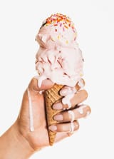 11453476-A-hand-holding-a-melting-ice-cream