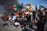 1749401404_955_Mexican-flag-waving-masked-protester-becomes-the-symbol-of-LA-anti-ICE-1452415569
