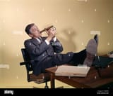 1960s-successful-businessman-sitting-with-shoes-propped-on-desk-lighting-CMRP40