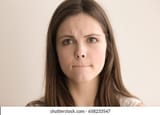 headshot-portrait-indecisive-young-woman-260nw-658233547