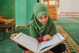 muslim-girl-reading-holy-book-quran-inside-mosque_606562-217