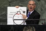 netanyahu-holds-a-chart-showing-iran-is-right-on-the-verge-v0-2xay6w1ji47f1