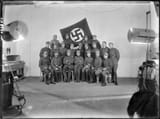SA-Sturme_group_portrait_Schellingstrasse_50_Munich_Germany_c_1923_Nazi_Party_NSDAP_Sturmabteilung_Bund_Ob...paramilitary_uniforms_Edelweiss_Ski_caps_Early_swastika_flag_Propaganda_Studio_National_Archives_NARA_Unrestricted_use_242