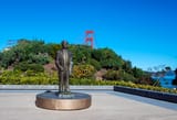 879_Highway - Bronze statue of a man stands in front of the Golden Gate Bridge