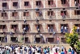 Indian parents scale school wall to help Grade 10 students cheat on exams. PATNA, India