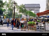 cafe-on-champs-elysees-with-arc-de-triomphe-in-paris-ANJ5F4