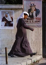 March 10, 1991 file photo, a poster of the Emir of Kuwait and a U.S. recruiting poster share space in a private compound, in Kuwait City