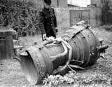 1944. British policeman and part of the V-2 rocket that fell on England