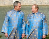 President George W. Bush speaks with Russian President Vladimir Putin, wearing chinamen clothes