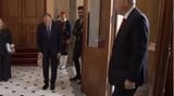 greek politician bows to his master