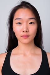 young-beautiful-chinese-woman-against-white-wall_251136-68650