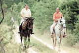Reagan and Bush on horseback at Camp David