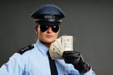 policeman-shows-money-uniform-gray-background-48663296