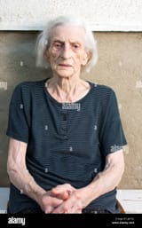 portrait-of-ninety-years-old-grandma-sitting-outdoors-JJK7X2