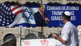A person walks near a congratulatory billboard for U.S. President-elect Donald Trump, following the 2024 U.S Presidential Election, in Jerusalem, November 7, 2024. REUTERS.png