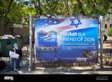 a-woman-waits-for-transportation-next-to-a-billboard-welcoming-president-donald-trump-ahed-of-his-visit-in-jerusalem-friday-may-19-2017-president-trump-will-pay-a-two-day-visit-to-israel-and-west-bank-on-may-22-and-23-2017-ap-photooded-balilty-2MTP9A