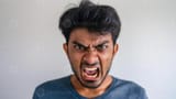 angry-south-asian-man-yelling-intense-facial-expression-in-indoor-setting-photo