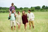 family-walking-through-field