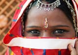 Enchanting-Travels-India-Tours-Traditional-Indian-woman-in-sari-costume-covered-her-face-with-veil-e1697486652742