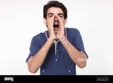 young-man-shouting-with-hands-cupping-mouth-WAMGEM