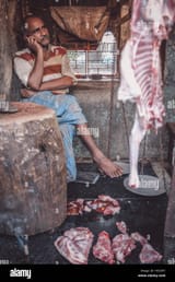 mumbai-india-12-january-2015-indian-butcher-speaks-on-cellphone-at-H033HT