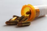 bullets-spilling-out-pill-bottle-600nw-1402919351