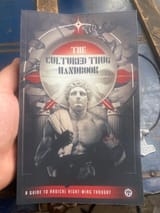 people holding the cultured thug handbook 3