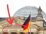 close-up-view-of-german-flag-on-a-background-reichstag-building-the-seat-of-the-german-630496228