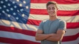 patriotic-young-man-smiling-in-front-of-american-flag-us-pride-concept-photo
