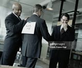 businessman-with-kick-me-sign-on-back