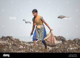 a-women-from-indigent-community-collecting-usable-things-for-sale-from-a-garbage-pile-in-matual-demra-dhaka-bangladesh-february-6-2008-W2M3YJ-3684298178