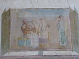 VIII.1.a,_Pompeii._June_2017._Painted_panel_from_west_end_of_south_wall_of_enthroned_Pindar_with_lyre,_with_Muse_and_poetess