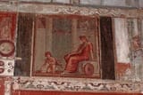 VI.17_Herculaneum._February_2003._Painting_from_south_wall_of_oecus_of_a_Maenad_sitting_watching_boy_Pan