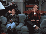 Elaine-Benes-and-Jerry-Seinfeld-Sitting-on-Couch-Smoking-Cigars[1]