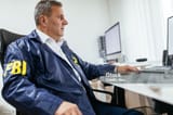 fbi-agent-using-computer-in-office-3662166183